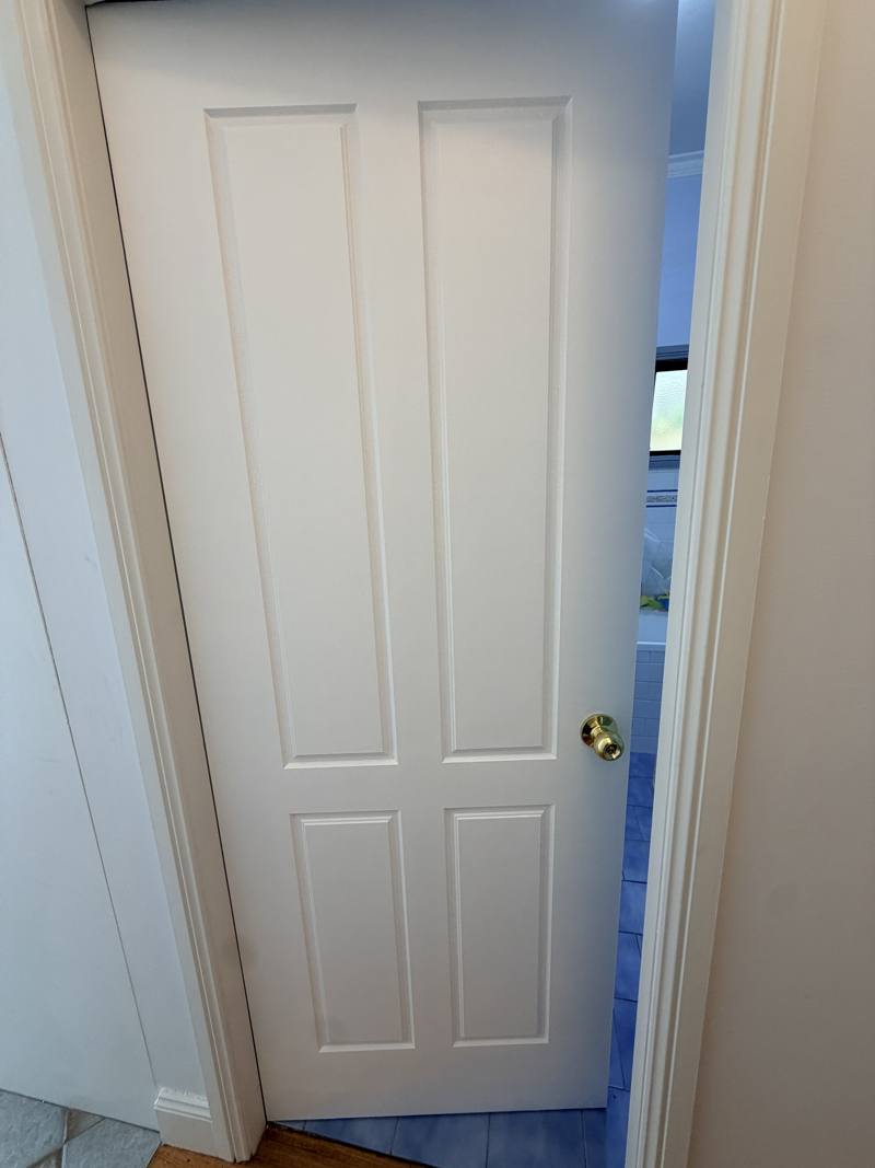 Custom white painted door fitted to a bathroom